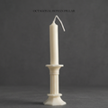 Decorative candle holder with a candle on a dark background