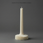Radiant fluted spire candle on a gray background