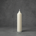 White candle with dimensions on a gray background