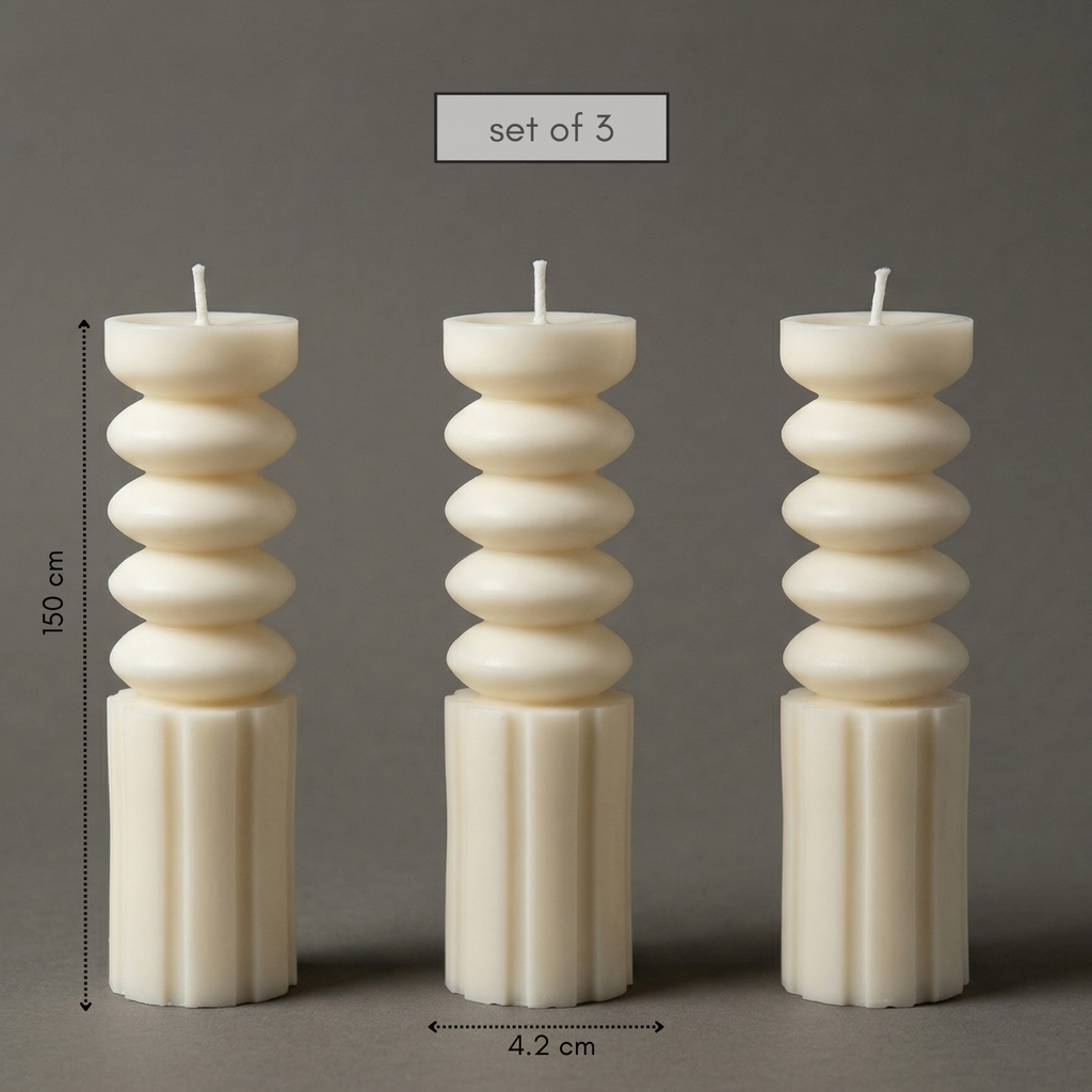 Set of three decorative candles with stacked design on a gray background