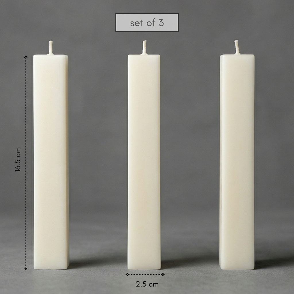 Three white candles of different heights on a gray background with measurements.
