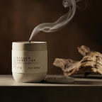 Candle with 'Saigon Heritage' branding on a dark background
