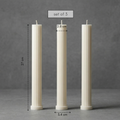 Three white candles of different heights on a gray background with measurements.